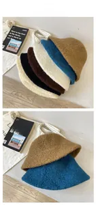 Flat lay display of colorful faux shearling bucket hats in warm autumn and winter tones