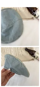 Detail of light blue washed denim beret featuring vintage stitching and paneled design