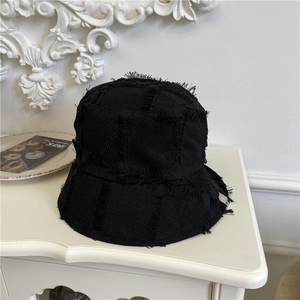 Black distressed canvas bucket hat with raw edges and subtle checkerboard texture