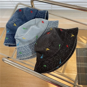Denim bucket hats with colorful dinosaur embroidery in black, light blue, and dark blue