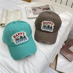 Retro distressed baseball caps in blue and brown with vintage Happy Camper embroidery