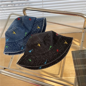 Blue and black denim bucket hats with colorful dinosaur embroidery and washed texture
