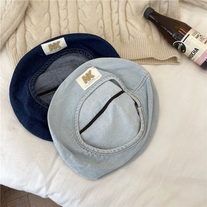 Fashionable washed denim beret hats in dark and light blue with vintage NK metal badge