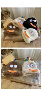 Detailed close-up of soft fuzzy knit beanie with cartoon eyes and spiral top decoration