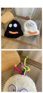 Detailed close-up of fuzzy monster hats with rainbow spiral antennas and cartoon faces