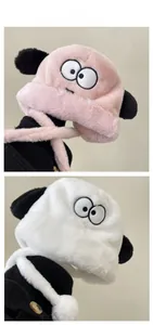 Detail of plush ear-flap hats in pink and white with cute cartoon embroidery
