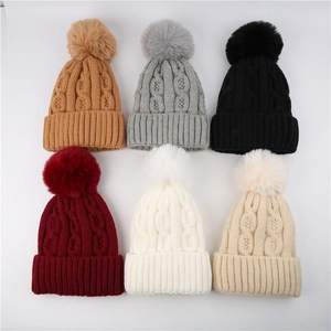 Thick cable knit beanie for women featuring large faux fur pompom in six classic colors