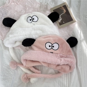 Cute plush puppy earflap hats in white and pink with fuzzy pom-poms for winter warmth