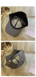 Detail of dark grey distressed baseball cap with metal buckle and cotton twill texture