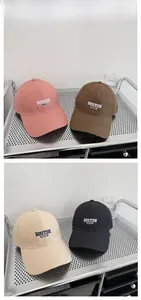 Close-up of Boston 1630 embroidery on cotton baseball caps in four assorted colors
