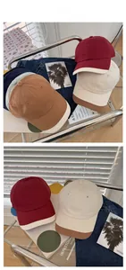 Detailed tile display of color block baseball caps in burgundy, beige and brown cotton