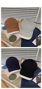 Detailed tile display of four color-block cotton baseball caps in earthy neutral tones