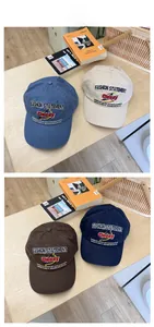 Detailed view of four cotton baseball caps in blue, beige, brown, and navy with 3D embroidery