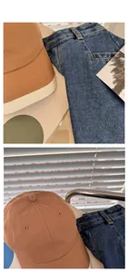 Detail of a brown cotton baseball cap and blue denim jeans under natural light shadows