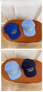 Detail of WEEKENDNEED Original letter embroidery on blue cotton flat brim caps