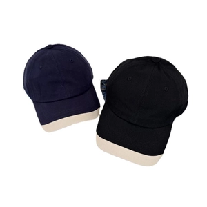 Navy and black baseball caps with beige brim contrast in a minimalist casual design