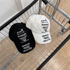 Retro street style baseball caps in black and white with vintage text embroidery in a cart