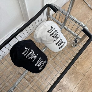 Retro hip-hop baseball caps in black and white with vintage letter prints in a basket