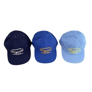 Three vintage embroidered cotton baseball caps in dark, medium, and light blue shades