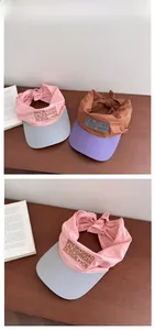 Detail of embroidered quick-dry visor hats with bow ties and sun protection style