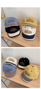 Detail of color block baseball caps with mountain embroidery and adjustable straps