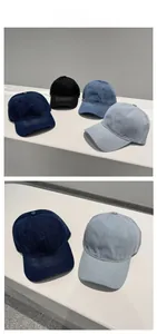 Detail showing four shades of denim baseball caps with adjustable six-panel structure