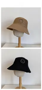 Close-up of flower embroidery and raw edge detail on cotton canvas bucket hats