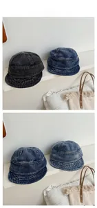 Detail of washed denim fisherman hat with vintage stitching and foldable soft brim