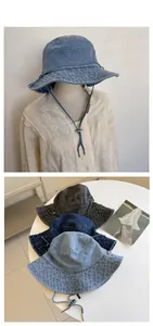 Detail view of washed denim bucket hats in three colors with adjustable chin straps