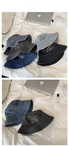 Detail of washed denim bucket hats with Rolling Hearts Club embroidery and vintage texture