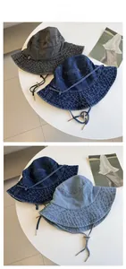 Detail view of washed denim bucket hats in three colors with adjustable chin straps