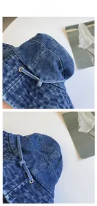 Close-up of deep blue denim bucket hat with metal eyelets and reinforced stitching