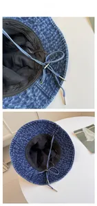 Detail of dark blue washed denim bucket hat showing breathable mesh lining and windproof rope