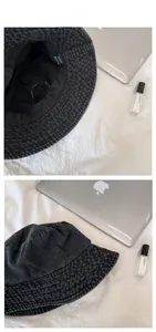 Detailed view of dark grey washed denim bucket hat with stitching and inner brand label