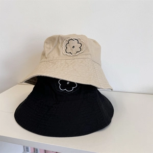 Beige and black cotton bucket hats with flower embroidery and frayed edges design