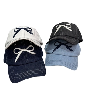 Sweet baseball caps with embroidered bows in navy, beige, black, and light blue colors
