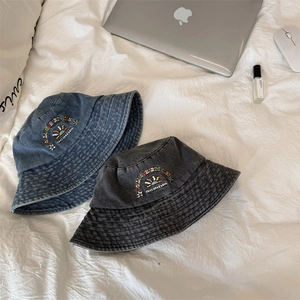 Vintage washed denim bucket hats in indigo and grey with rainbow heart embroidery