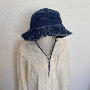 Vintage dark blue denim bucket hat with adjustable chin strap and washed cotton finish