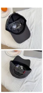 Detail view of washed dark grey cotton baseball cap showing adjustable metal buckle and strap