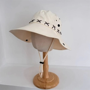Cream canvas cowboy sun hat with cross-stitch details and adjustable chin strap