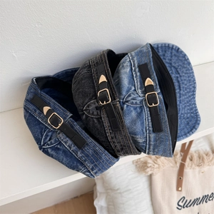 Three vintage washed denim berets in blue and black with adjustable leather straps