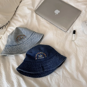 Washed denim bucket hats with sun embroidery in light and dark blue colors