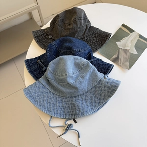 Three denim bucket hats in various washes with adjustable windproof cords and metal buckles