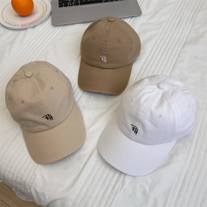 Three cotton baseball caps in white, beige, and brown with RH letter embroidery