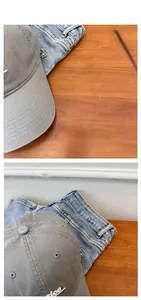 Detail view of grey cotton baseball cap showing white nice embroidery and fabric texture