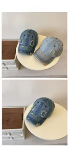 Detail of distressed denim baseball caps showing ripped holes and frayed edge texture