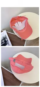 Detail of coral pink baseball cap showing internal lining and adjustable metal buckle