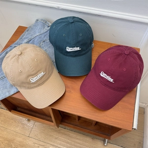 Three cotton baseball caps with Consice embroidery displayed on a vintage wood surface