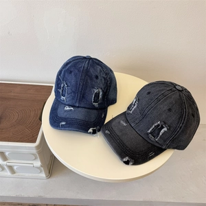 Retro distressed denim baseball cap with ripped details in navy blue and charcoal black