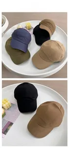 Detailed view of water-resistant five-panel caps in various colors on a white tray